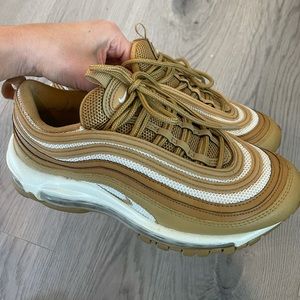 Nike women’s air max 97’s in gold color way.